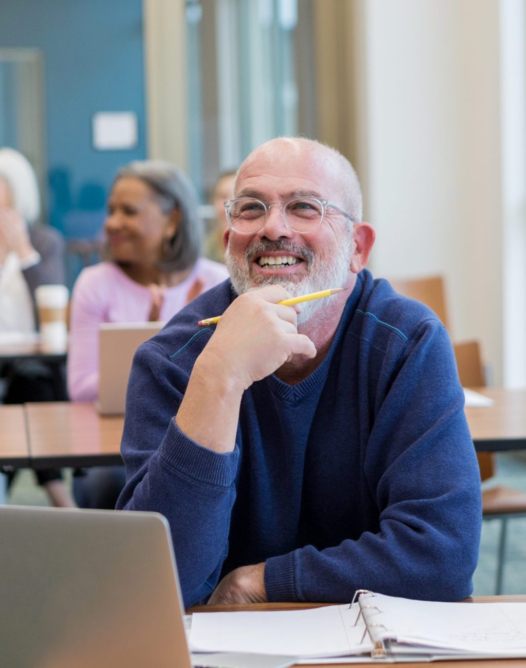 Diverse group of students have fun during their adult ed class at the local college.