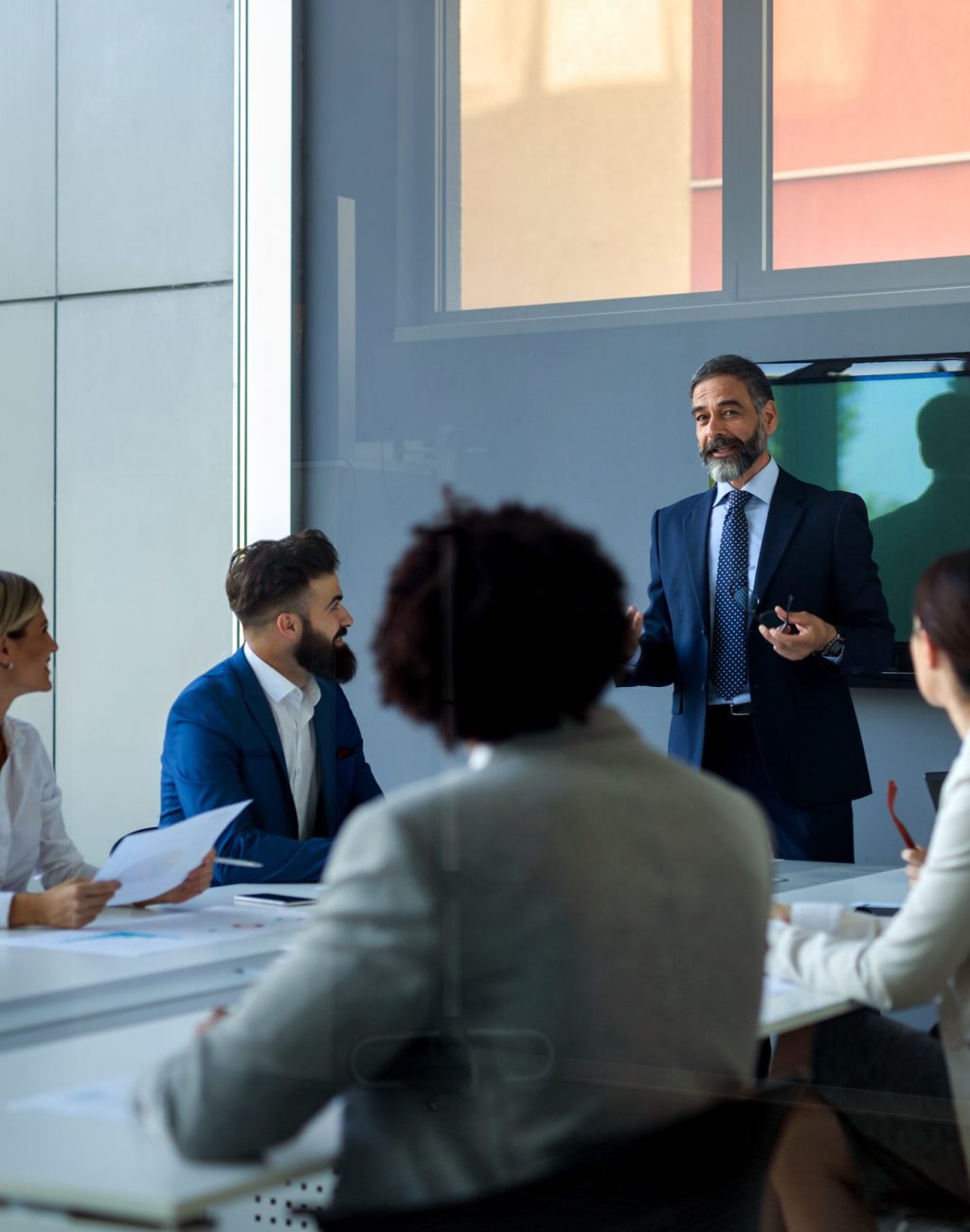 Diverse business team working together on meeting, analyzing financial documents in office