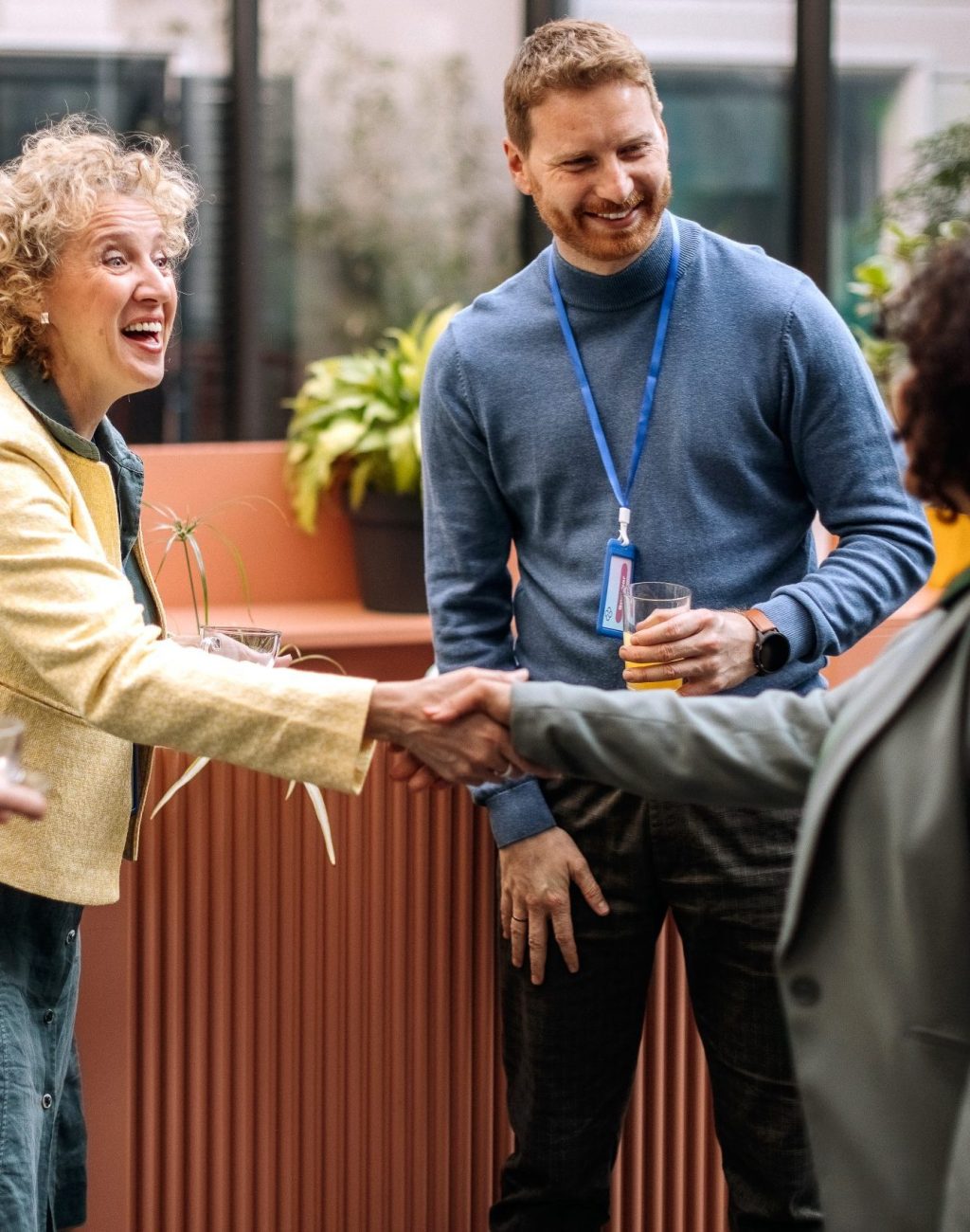 Business people on a break while attending business conference, greeting and shaking hands